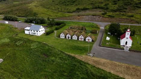 aerial shot approaching towards the turf houses, historical in iceland