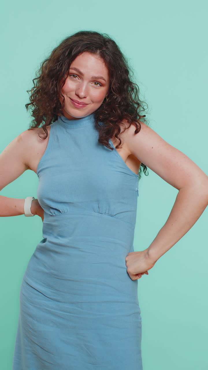 Young caucasian woman pointing finger to camera making winner choice showing direction