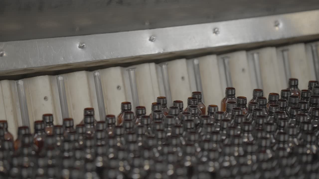 Syrup bottles coning out after a wash slog footage.