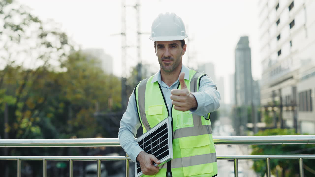 Engineer with solar panel giving a thumbs up