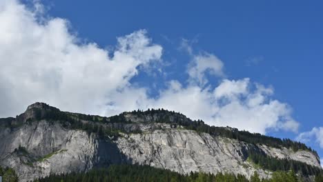 timelapse: view of a rocky mountain in the bernese alps, clouds moving above it