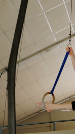 gymnast practicing with ring row