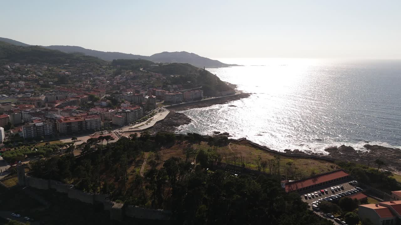 Aerial of Bayona, Galicia, Spain, overlooking the coastal town and shimmering ocean