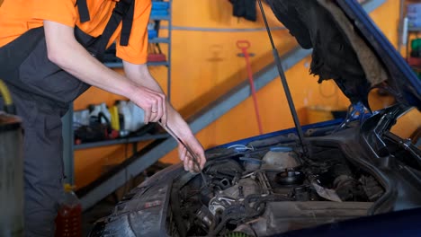 mechanic working on a car engine in an auto repair shop