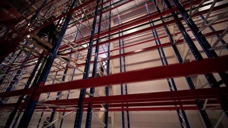 big and modern warehouse under construction, featuring metal shelving and other industrial equipment.