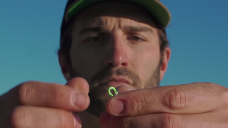 Close-up-of-a-male-fisherman's-hands-prepping-a-fly-fishing-reel