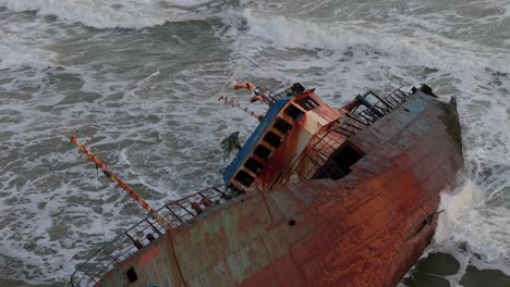 a wrecked rusty old ship washed ashore on a beach filmed in slow motion in lagos, nigeria