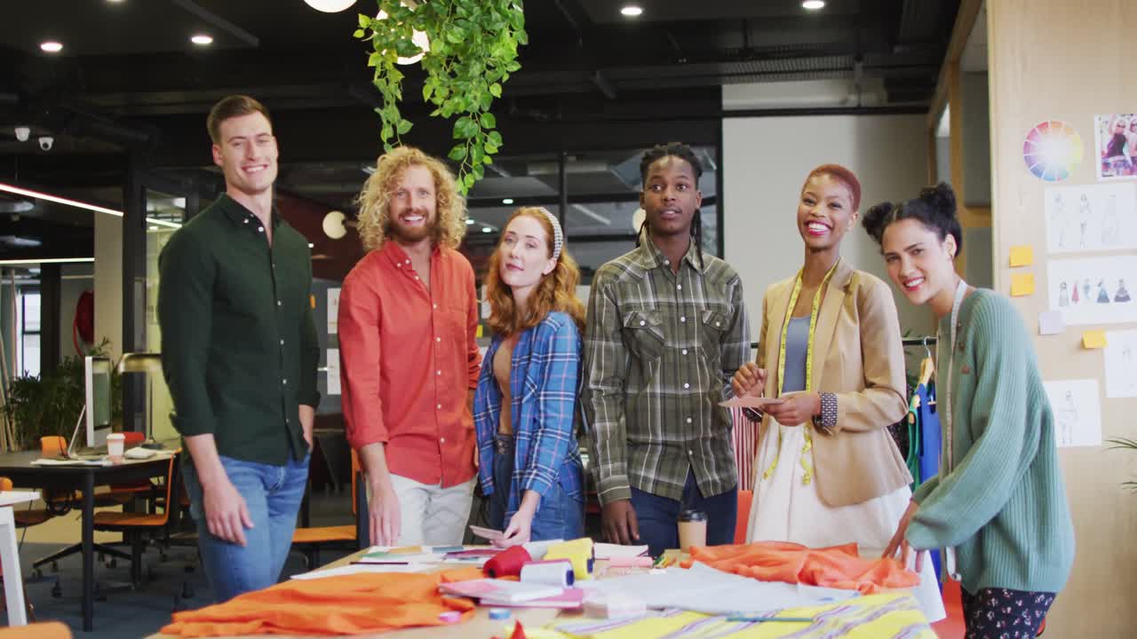 Portrait of happy diverse business people looking at camera at office