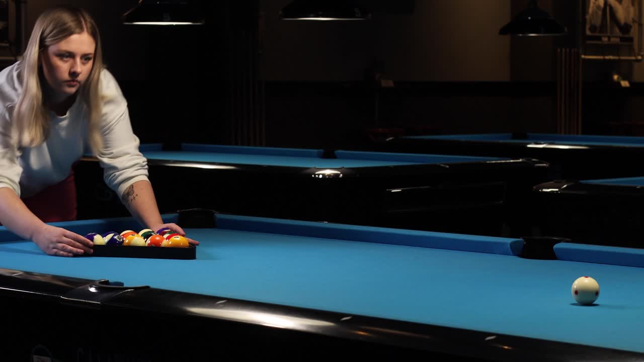 Setting up the rack for the start shot at a game of pool billiards