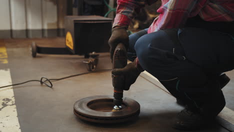 mechanic working on car parts in a workshop