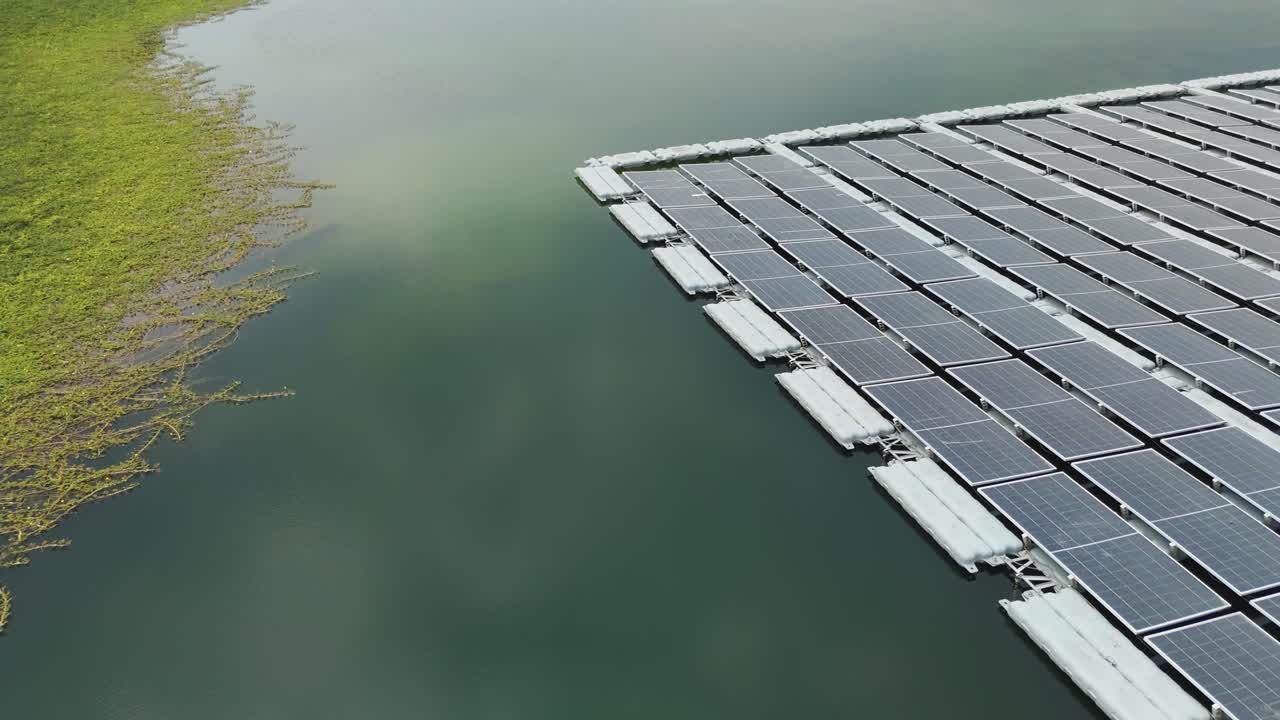 Drone fly over floating solar panels installed on the surface of a lake ...