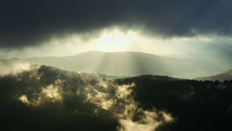 drone flying above the mountains with clouds, in slow motion