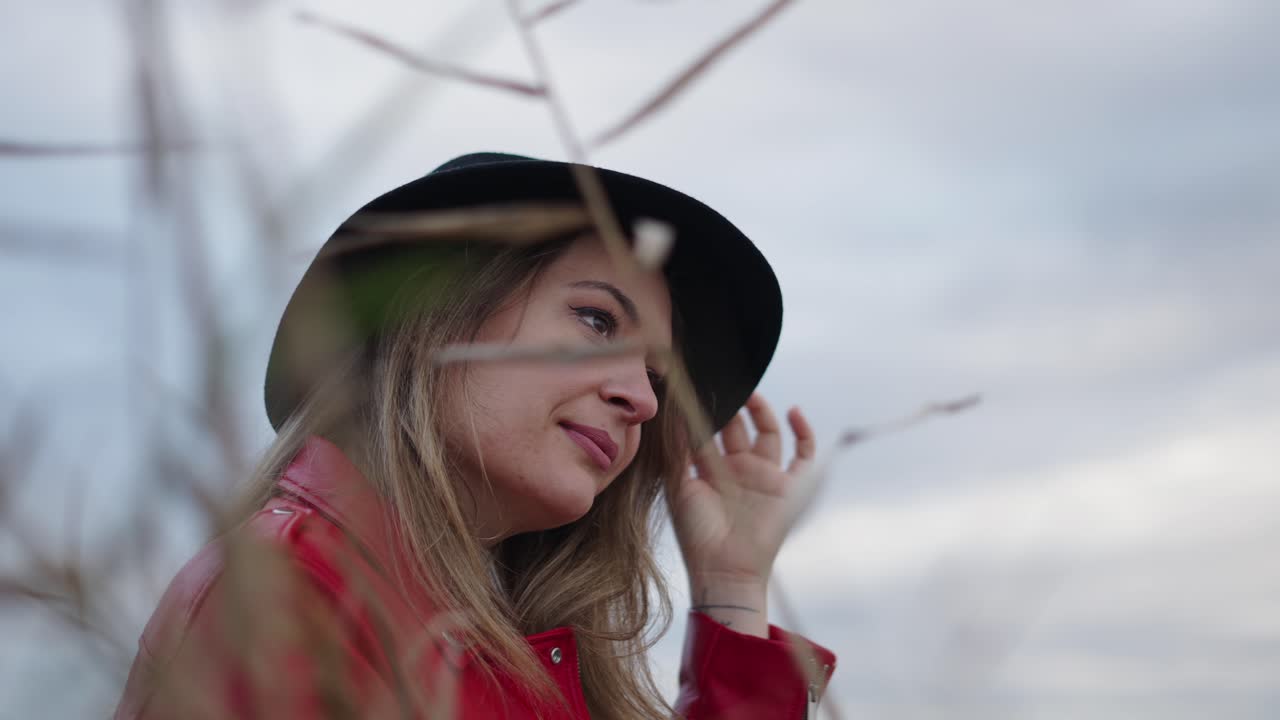 Woman in a Red Jacket and Black Hat