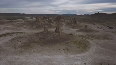 drone flying backwards, revealing camp site at trona pinnacles in california, a location for many movies and commercials