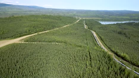 Alaska---Boreal-Spruce-Forest-and-Yukon-River-Landscape-Around-Pipeline---Road,-Aerial-Drone