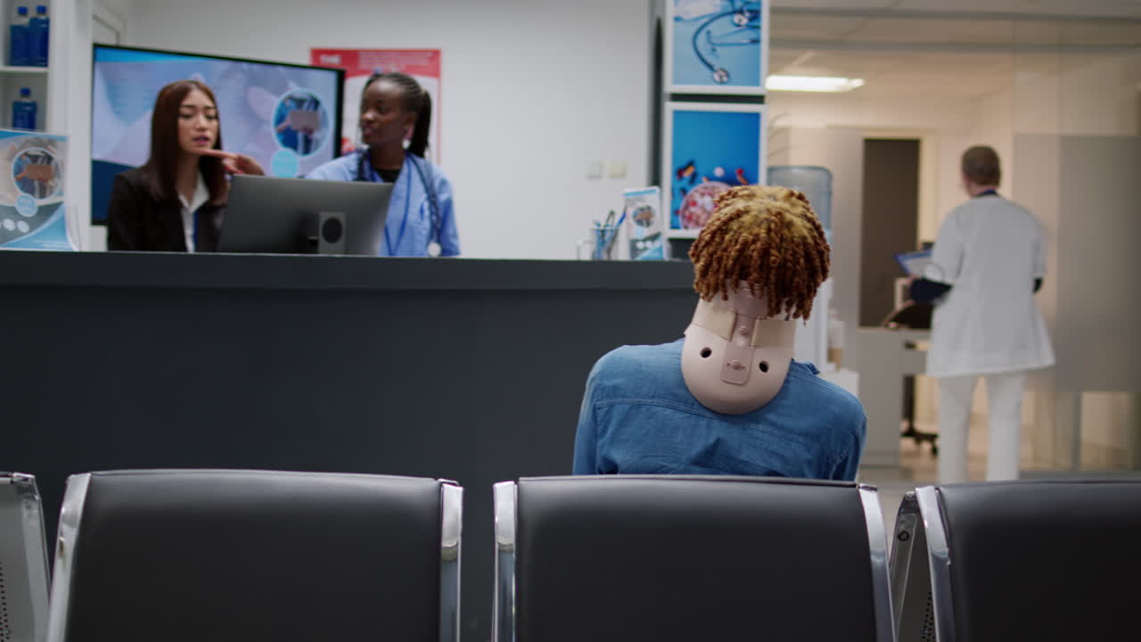 Hospital waiting room with patients and staff