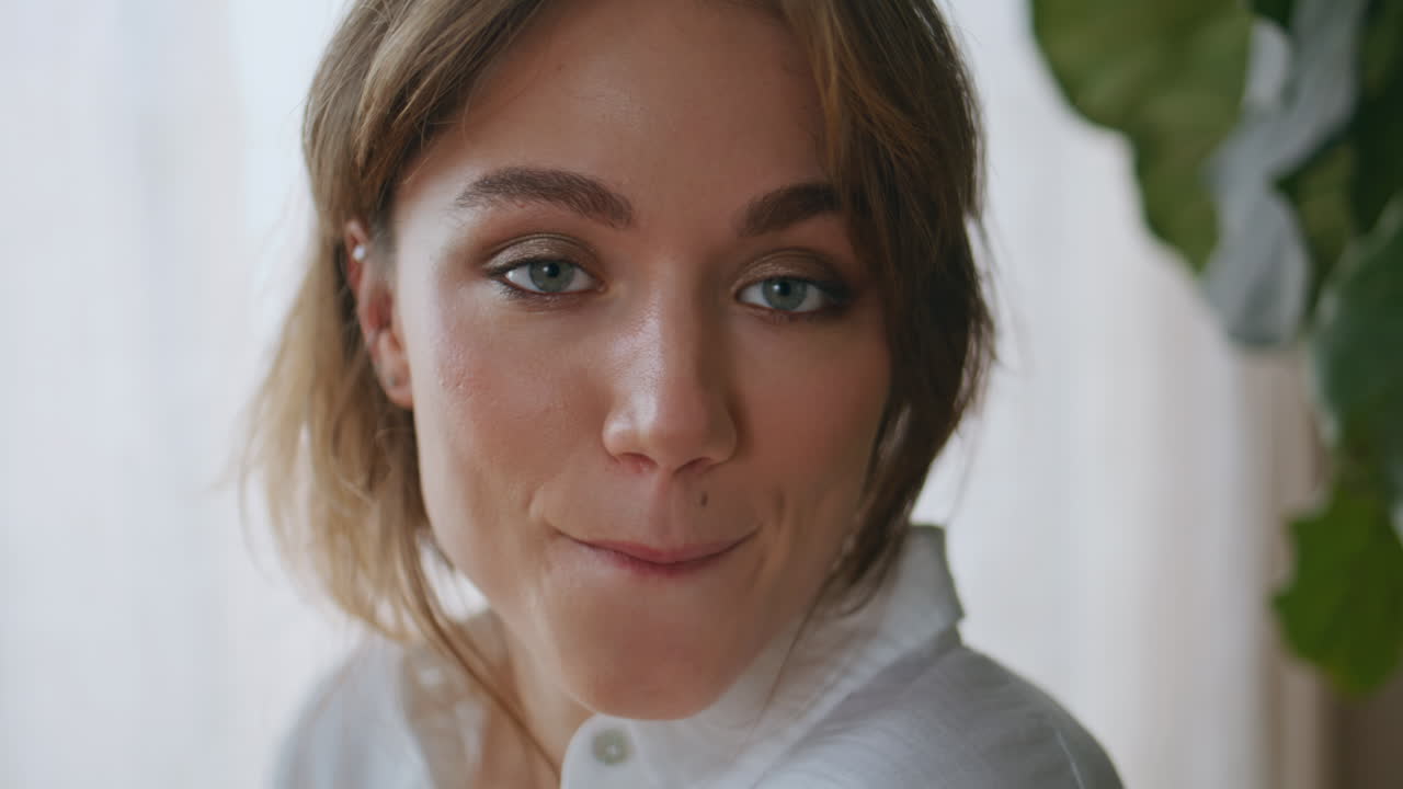 Portrait serene woman smiling at home. Relaxed lady looking camera at morning
