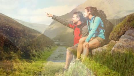 hiking and exploring nature, couple sitting on rock in mountainous landscape