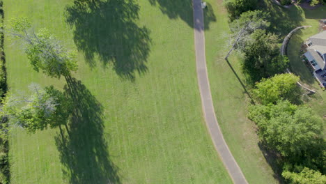 Walking-path-curves-through-a-freshly-mowed-field,-summer-spring-day