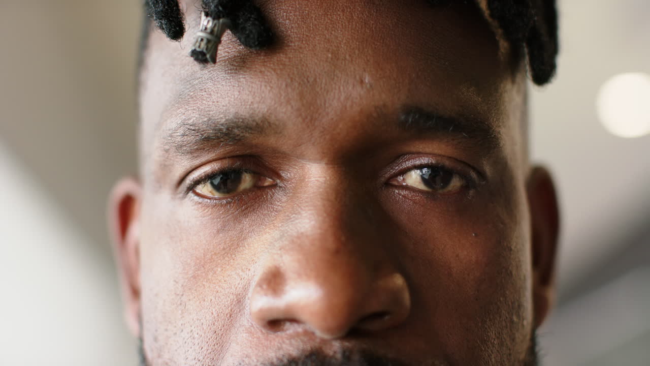 Close-up of mans face with focused expression, eyes looking straight ahead