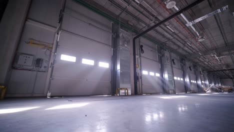 there are automatic gates at a large warehouse. the gates are used for loading cargo from large trucks.