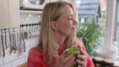 a woman drinking coffee in the kitchen