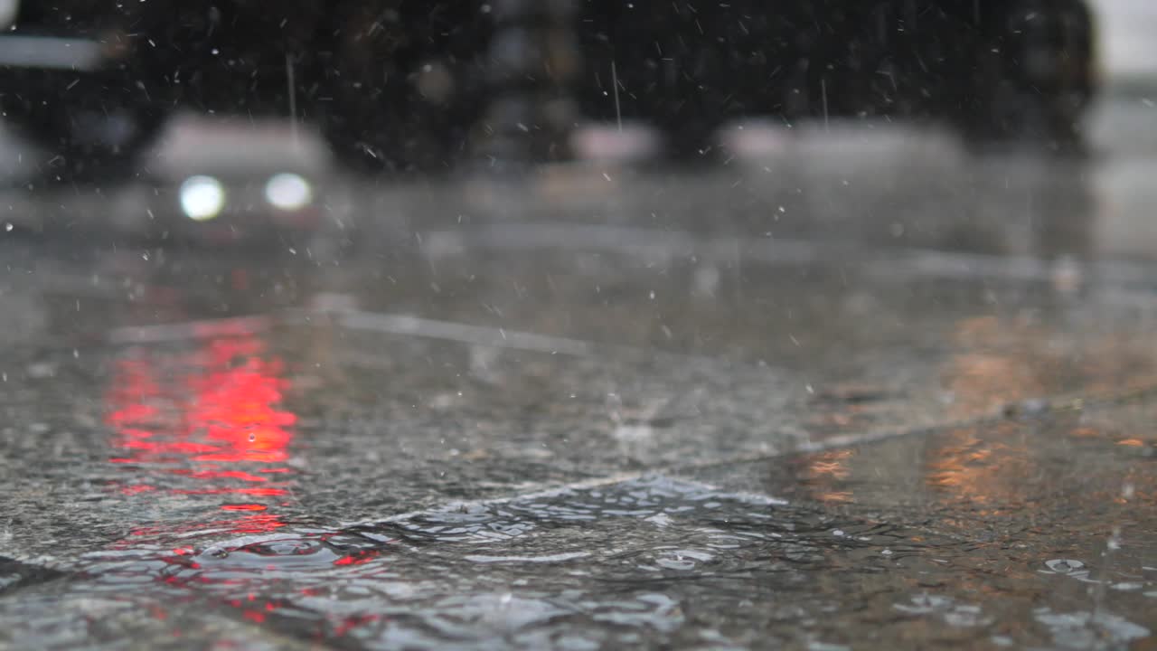 Close-up of Rain Falling on a Wet City Pavement