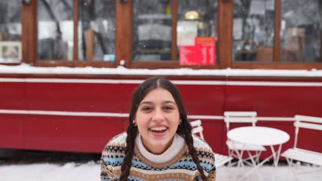 teenage girl smiling in snowy cafe