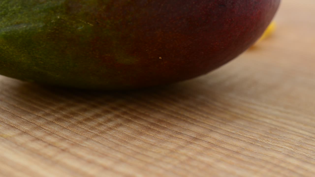 Pezzi di mango su un tagliere di legno. Riprese in movimento