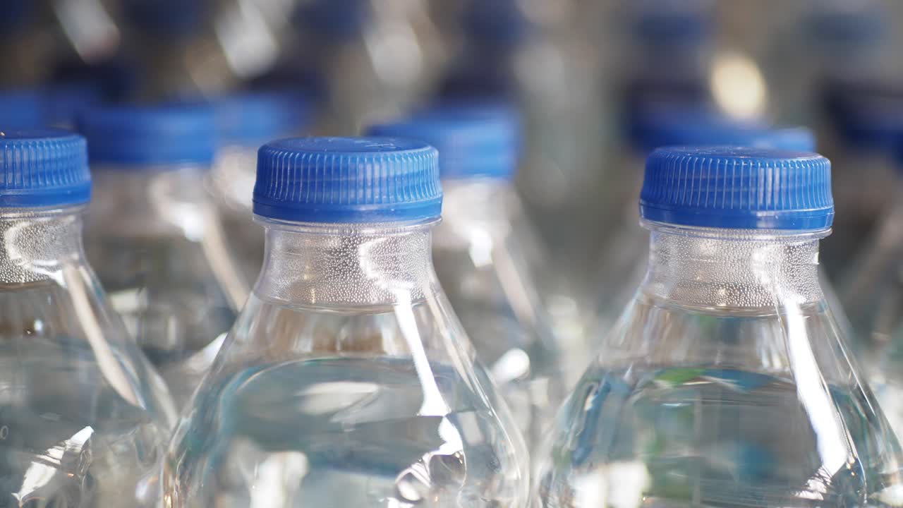 Close-up of a Row of Water Bottles with Blue Caps