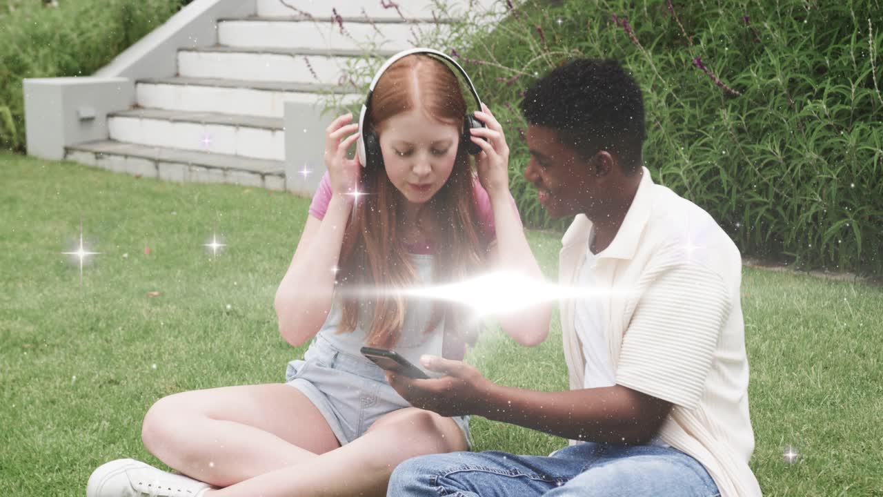 Man offering phone, woman placing headphones, tapping screen, sharing music, sparkles growing