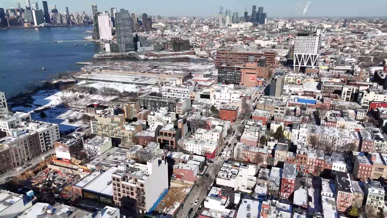 Horizontal drone side panning shot over Wythe Ave in Williamsburg, Brooklyn, capturing vibrant urban streets, dynamic rooftops, and New York’s charming cityscape in smooth motion.