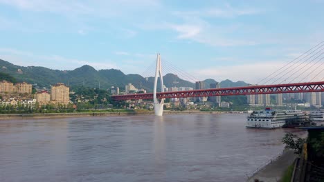 Slow-motion-video-clip-of-steel-and-cable-impressive-DongShuiMen-bridge-above-mighty-Yangtze-river-Chongqing-town-city-in-China