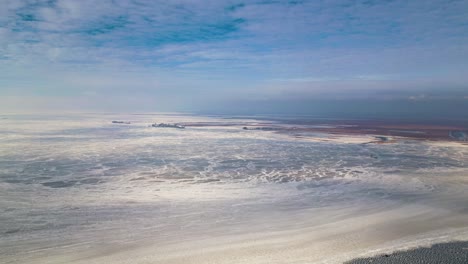 Lake-St-Clair-Aerial-view-of-frozen-lake,-Mitchell's-Bay-60fps-during-winter,-USA-Canada-border