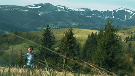 Little-boy-walking-across-meadow.-Young-tourist-in-wild-environment