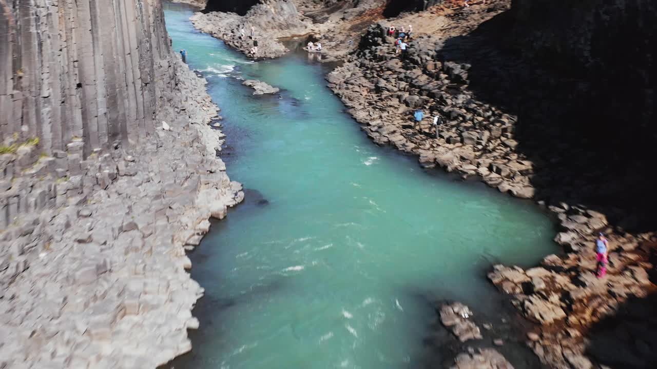 Aerial through Studlagil ravine with basalt columns in Iceland, tourist location
