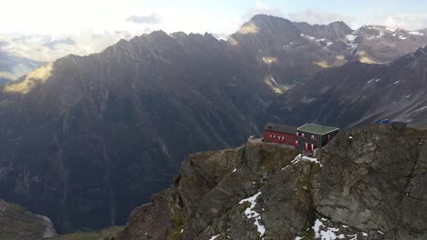 aerial shot of the dossen hut on top of the mountain, right on the steep cliff in the swiss alps