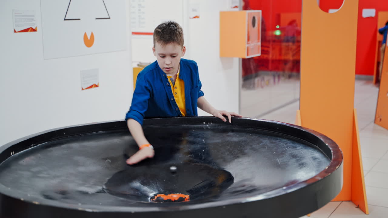 Boy in the museum science. A planet swallowed by black hole simulation, endless gravity