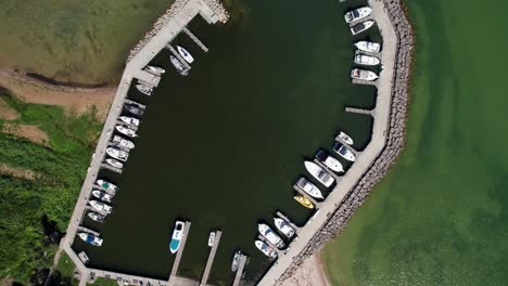 drone aerial view looking straight down at a marina full of boats in lake michigan