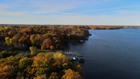 aerial view of homes and trees by the lake front in minnetonka, minnesota during autumn colorâ€™s peak