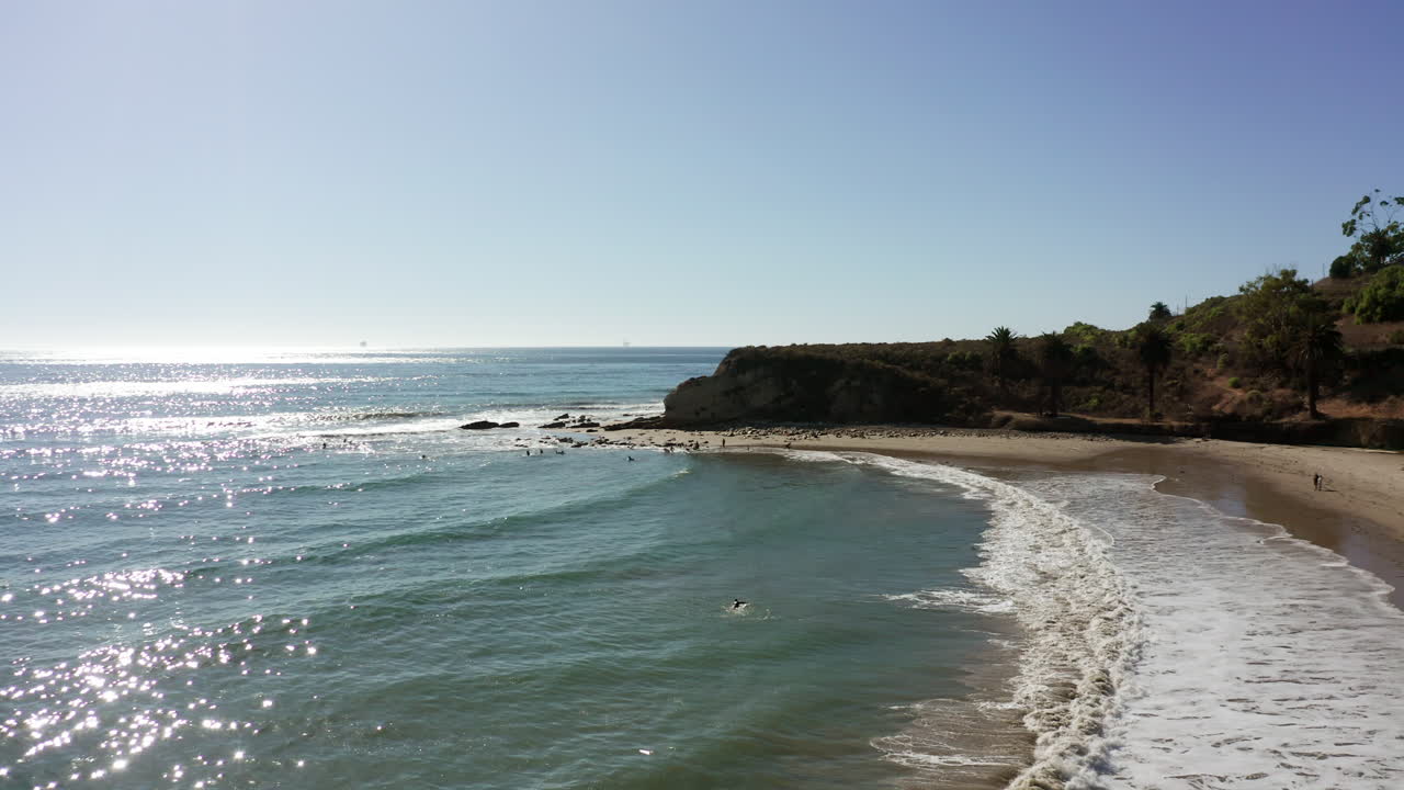 Vista aerea: luce solare che luccica su una spiaggia tranquilla della costa della California.