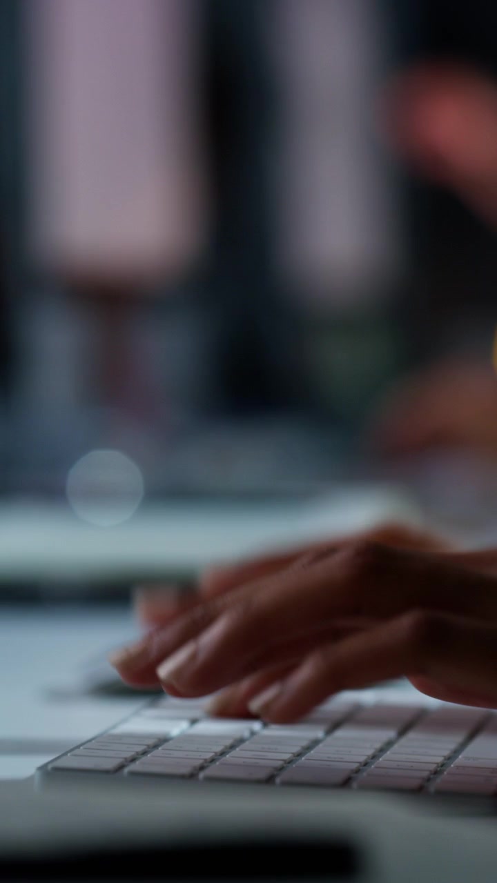 Close-up of Person Typing on Computer Keyboard in Office