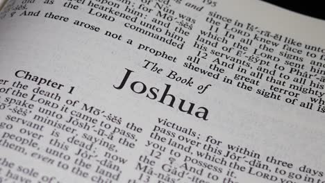 close up shot of bible turning to the book of joshua