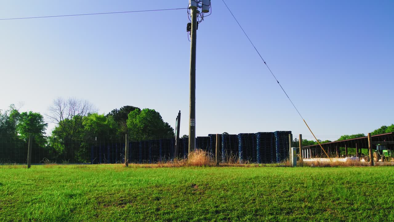 Stacked Wood Pallets in Rural Outdoor Storage Yard on Sunny Day