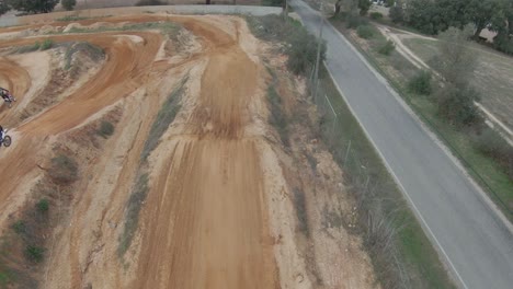 Aerial-FPV-slow-motion-follow-of-motocross-dirt-track