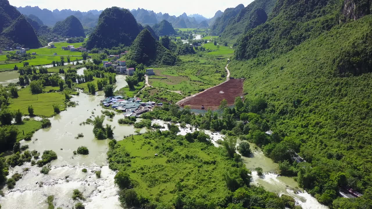 Aerial view of Ban Gioc Waterfalls in lush mountainous landscape