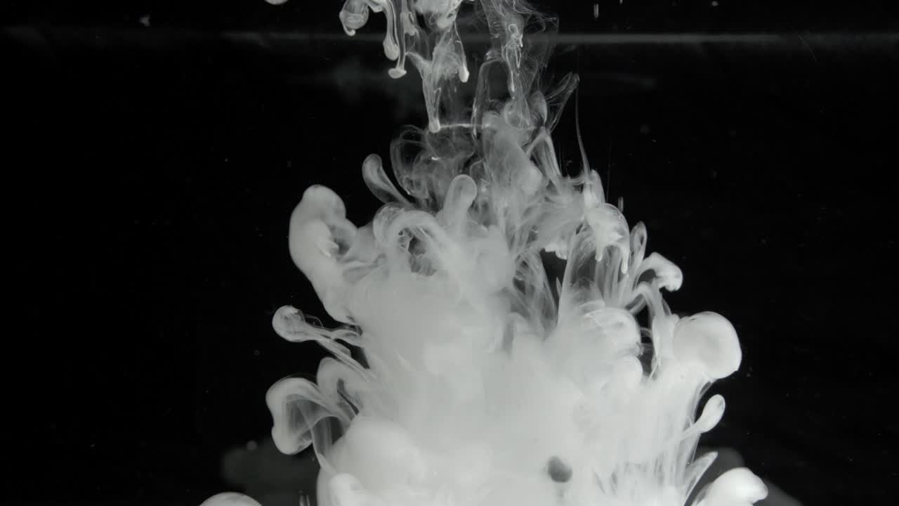 White Ink Effect In Water Filmed On Black Background