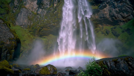 rainbow waterfall in a mountainous landscape