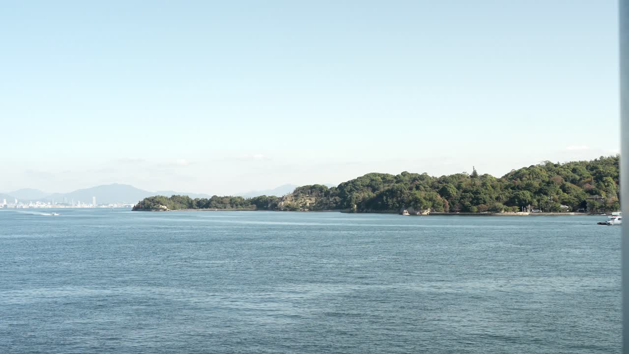 The view of Itsukushima island from a ferry in Hiroshima, Japan.