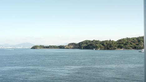 the view of itsukushima island from a ferry in hiroshima, japan.